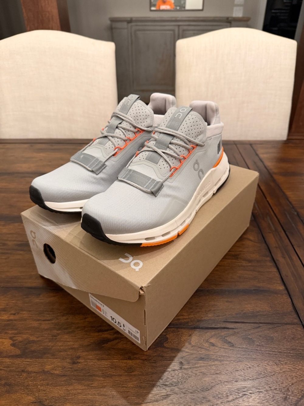 On Running Men’s Athletic Sneakers in Light Gray with Orange Accents